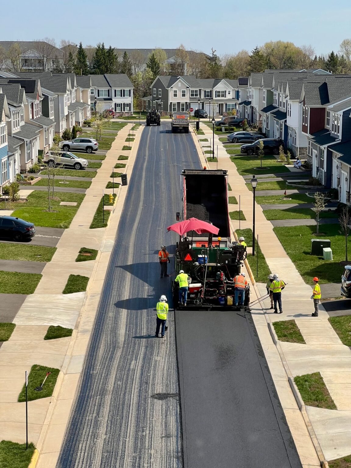 Asphalt paving crew repaving a street in Cedar Rapids, IA